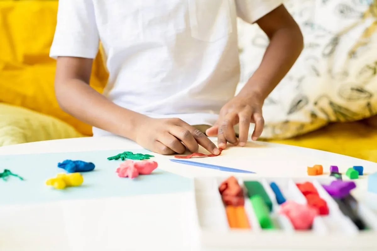 Boy playing with modeling clay.