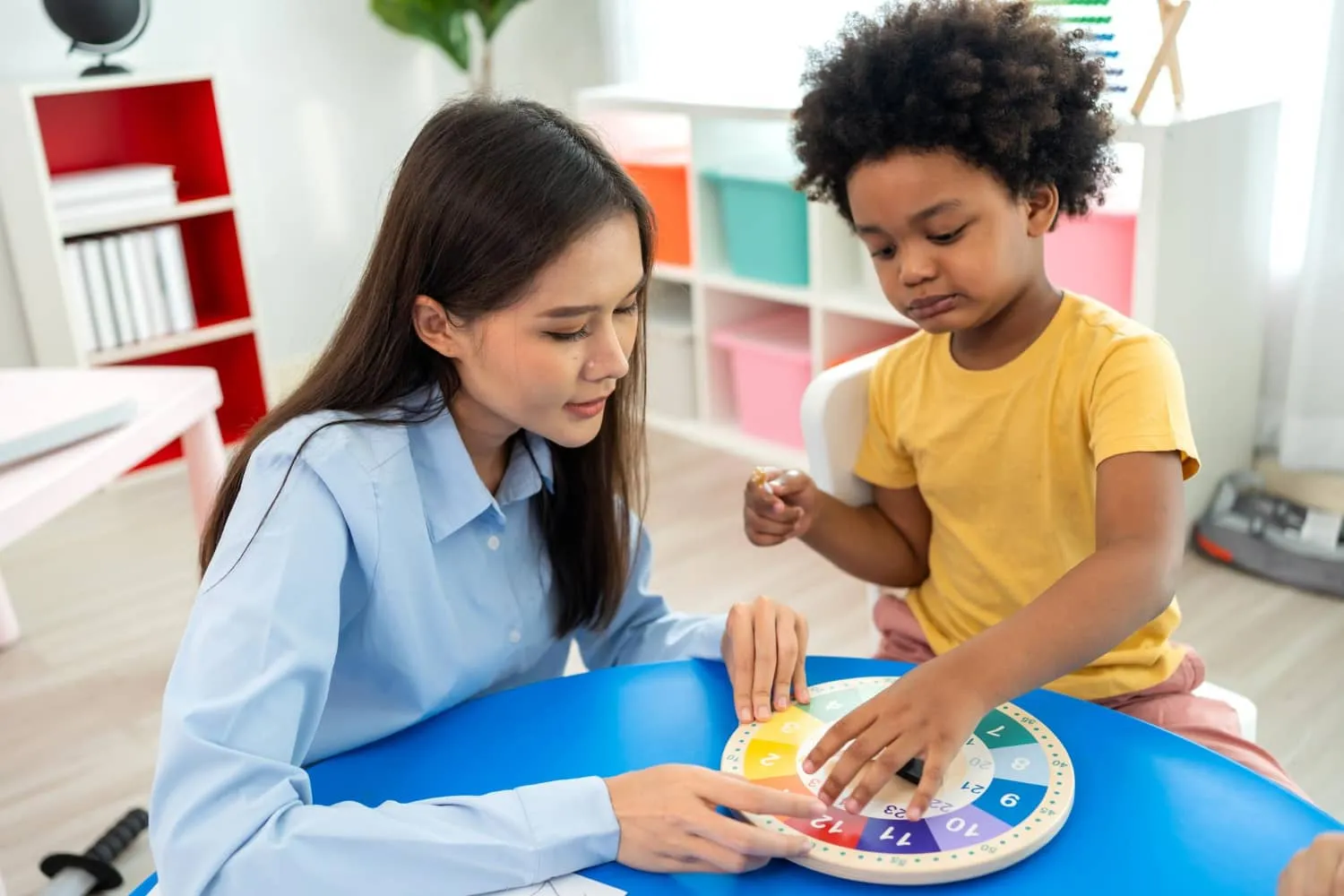 Therapist engaging in a Occupatioinal Therapy session with a child.
